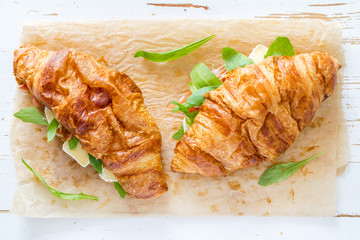 Sandwich croissant with ham brie arugula