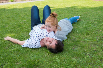 mother and girl on the grass, girl s head on mothers chest