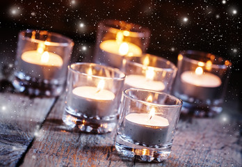 Burning small candles in glass candlesticks, Christmas or New Ye