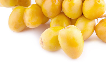 Fototapeta na wymiar yellow raw dates isolated on white background