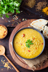 Red lentil Indian soup with flat bread. Masoor dal. 