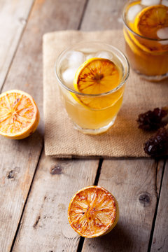 Lemonade in glasses and bottles made of grilled lemons. Cider.