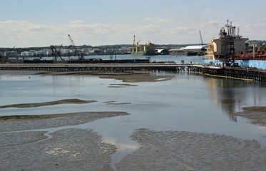 pier at the harbor on Fore River during low tide, Portland Maine, Turner Island in the background