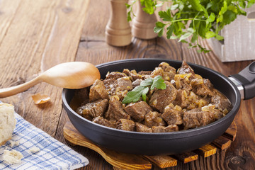 Beef stew - wooden background