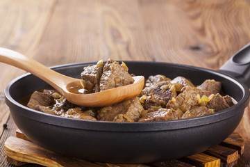 Beef stew - wooden background