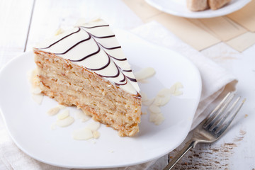 Traditional Hungarian Esterhazy cake with coffee cup and vintage postcards .