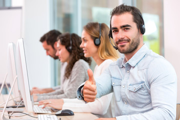 Young attractive man working in a call center