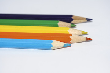 Row of coloured wooden pencils.