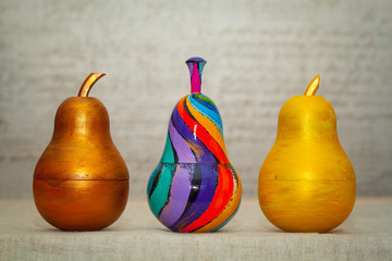 Three wooden decorative pear, colored paints. Understand how matryoshka