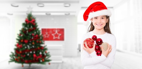 Composite image of festive little girl holding bubbles