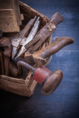 Group of vintage messy tools in wicker box construction concept