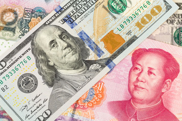 Obraz na płótnie Canvas US Dollar and Chinese Yuan banknote money