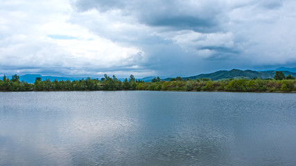 Big powerful storm clouds over the lake