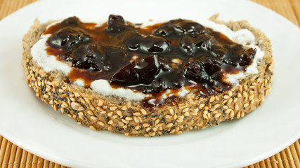 Slice of bread with yogurt and sour cherry jam, the perfect breakfast