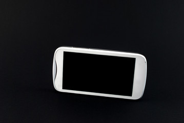 White touch screen mobile phone isolated on black background