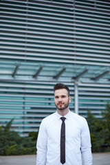 Businessman in front of building smiling, business centar, hipst