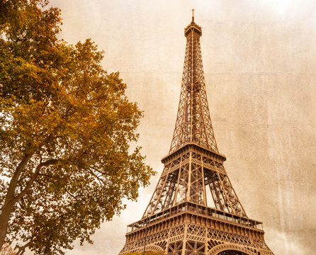 Eiffel tower in Paris on a cloudy day. Vintage style effect applied