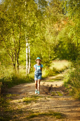 Girl walks through the birch forest