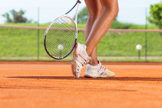 Legs of female tennis player.Close up image.