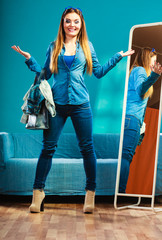 Fashion woman wearing blue denim in front of mirror