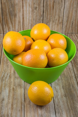 several pieces of orange fruit in a green bowl
