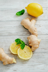 
Herbal tea with lemon , mint and ginger on a white wooden background