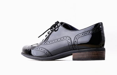 Footwear Concept. Horizontal Image. Pair of black female classic leather shoes isolated on the white background