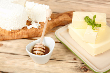 Dairy products on wooden table. Sour cream, milk, cheese, egg, 