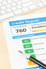 Credit score report with keyboard and pen
