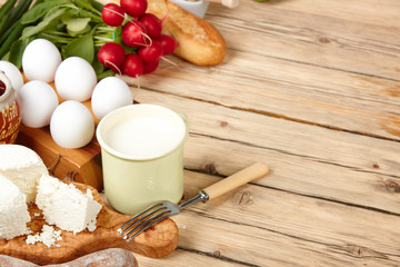 Dairy products on wooden table. Sour cream, milk, cheese, egg, 