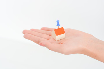 Close-up of woman's hands holding a small model house