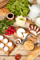 Dairy products on wooden table. Sour cream, milk, cheese, egg, 