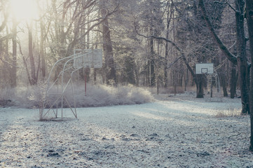 Abandoned street basketball hoop on winter frosty morning