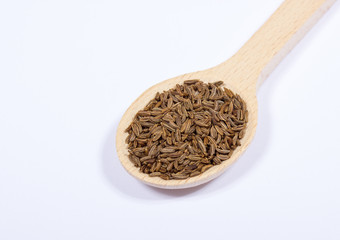 Ground cumin in a spoon.