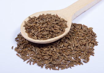 Ground cumin in a spoon.