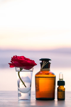 Aromatherapy essential oils in bottles on sunset 