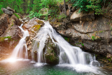 Naklejka premium falls of a little river in the mountain of italy