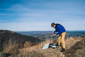 man holding a drone for aerial photography. silhouette against t