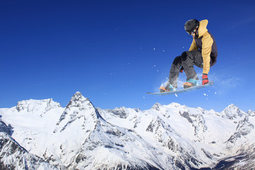 Flying snowboarder on mountains, extreme sport