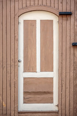 White door in wooden wall