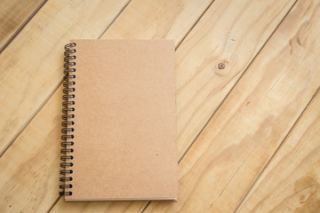 Top view of brown book on wooden table