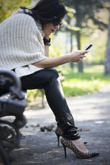 Attractive black haired woman using phone