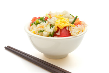 chinese cuisine - homemade fried rice with tomatoes and egg with chop sticks on white with clipping path