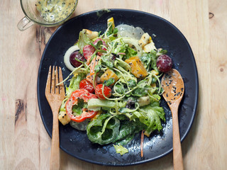 vegetable salad with sesame cream on wooden table