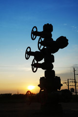 Fototapeta na wymiar In the evening of oilfield pipeline silhouette