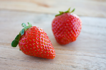 Ripe red strawberries on wooden table