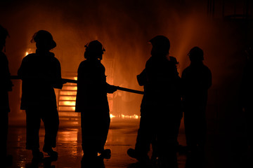 Firefighters training fighter at night.