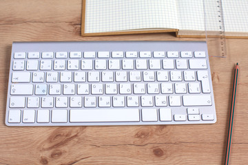 Office table with blank notepad and laptop 