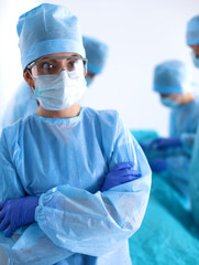 Team of surgeon in uniform perform operation on a patient at cardiac surgery clinic