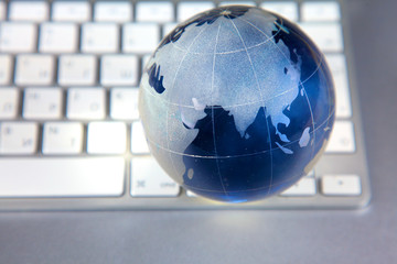 Cristal globe of the Earth on a Computer